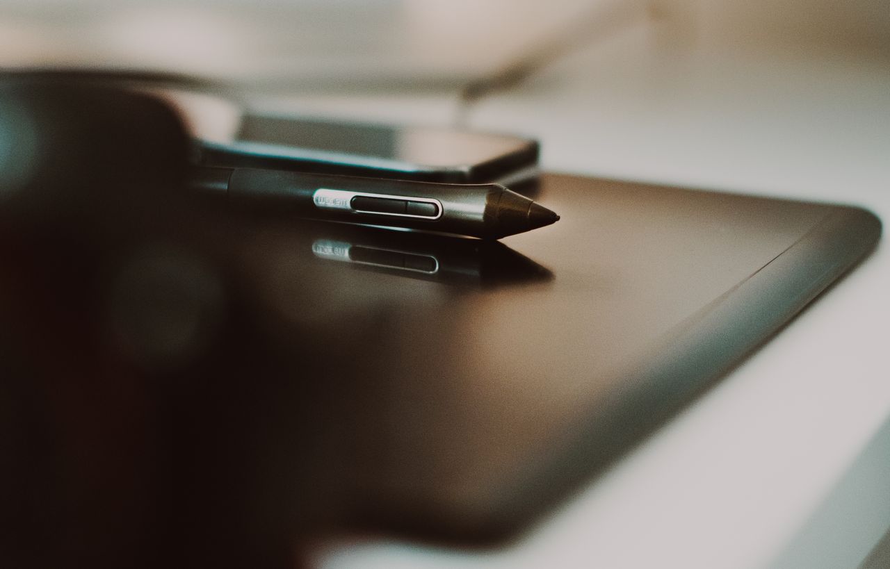 Offerings Close-up of a stylus and tablet on a desk, perfect for creative and tech themes.